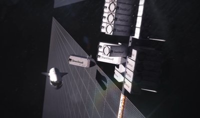 Artist's concept of a Starcloud orbital data center with large solar arrays deployed in space.