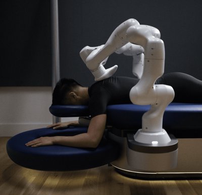 The Aescape robotic massage table with its two arms positioned over a person's back.